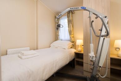 Accessible bed with hoist accommodation