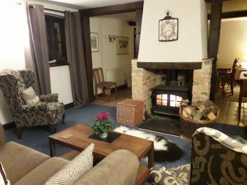 Guest lounge with comfortable seating area and woodburner.