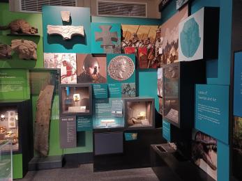 Museum display case featuring prehistoric and historic archaeology objects