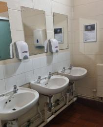 Sinks, mirrors and soap dispensers inside the toilets