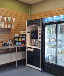 The self-service catering area in the Visitor Centre, with a fridge and a machine for dispensing hot drinks