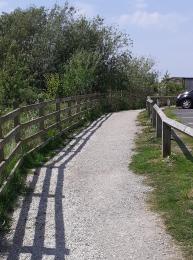 The footpath running along the length of the car park to the Welcome Point and Little Owl Café