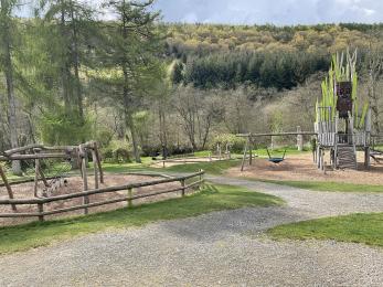 Pathways leading to Grandfather Oak play area with play equipment in the distance.