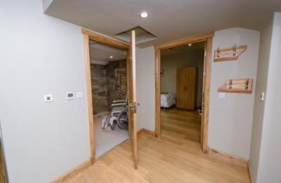 The large wet room is beside the twin bedroom with profiling bed.