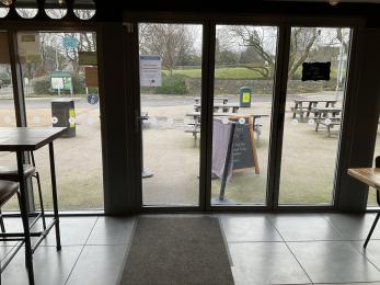 Glass entrance doors to the Blueberry cafe showing a-frame sign outside