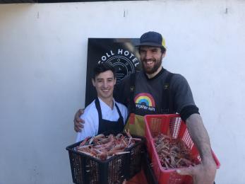 Chef Graham accepting delivery of fresh langoustines from Andrew. Our island fisherman