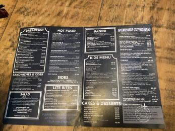 Black menu with white writing showing a variety of food including dietary options in the Blueberry cafe