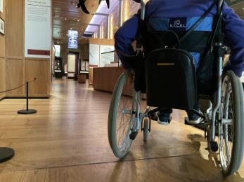Wheelchair user in Whitby Abbey Museum showing clear circulation space