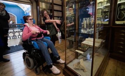 A photograph of two visitors enjoying the Sladen's Study gallery.