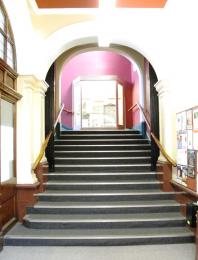 Stairs up to the gallery from the library
