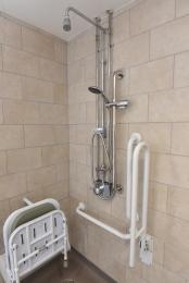 Colour contrast in the accessible shower areas with fixed pull down seat