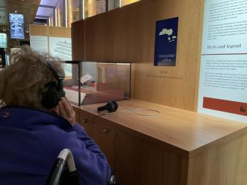 Wheelchair users in Whitby Abbey Museum listening to audio information through a earphones