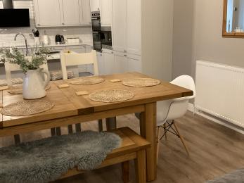 Open plan kitchen with central island and separate dining table