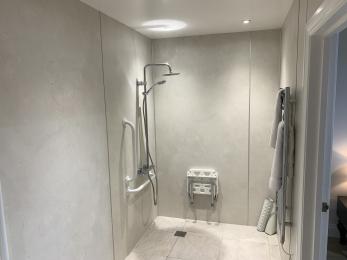 Accessible room shower with seat and rails