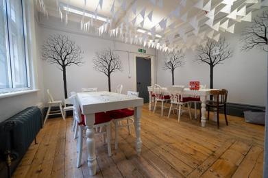 The tables and seating in the white Alice Room 