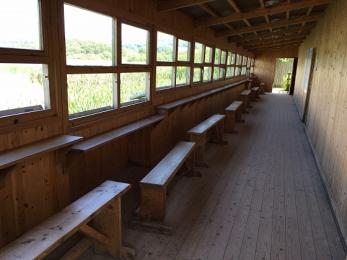 Causeway hide inside showing moveable benches and lowered viewing areas for wheelchair users