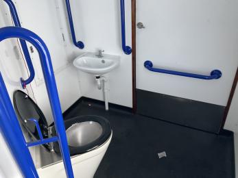 On board accessible toilet facility showing toilet, sink, grab rails and toilet layout