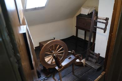 Room with spinning wheel.