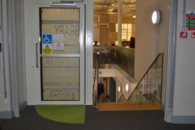 a photo of the platform lift next to the stairs, viewed from the first floor - the highest floor the lift can go to.