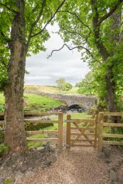 Gate from the beckside garden leading to a short but steep path down to the edge of the beck itself