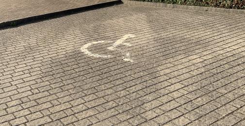 Accessible parking space on solid, block paved surface at the front of the Environment Centre next to the main entrance.