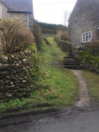 Path from road to main side entrance gate