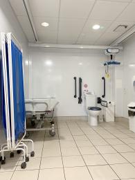 Interior of the ground floor accessible toilet showing the adult changing facilities, toilet and sink.