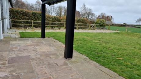 garden view with slabs on the patio and grass area