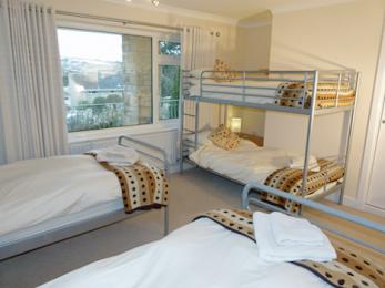 Ground floor quad bedroom with two single beds and one bunk bed suitable for adults