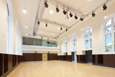 Picture of the Main Hall during daytime, a large bright space with glass stained windows