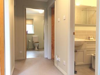 Entrance door and hallway leading to bedrooms, bathroom and shower room