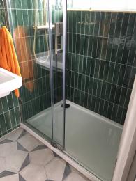 View of (downstairs) shower showing lip on shower tray