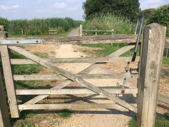 Entrance to RSPB Greylake - hard standing path through a wooden gate with a trombone latch