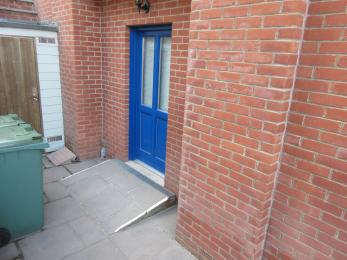 Side entrance door with ramp leading to ground floor of The Sea House