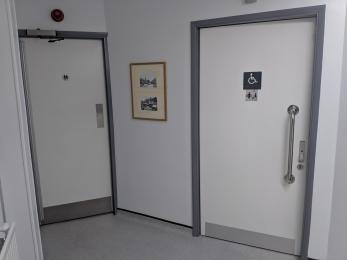 Doors to men's, women's and accessible toilets including a Changing Places facility.