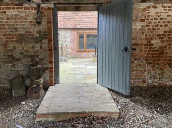 The step from the Cart Shed into the private garden and entrance to The Buttery.