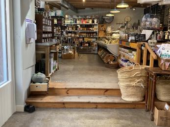 2 wooden steps that lead to the Deli cheese counter and till. 