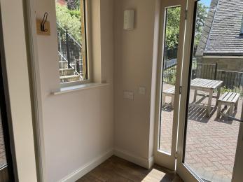 Powered wheel chair charging point in entrance porch