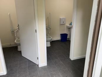 Interior Church toilets. Small hallway leading to two accessible toilets, one of the left and one on the right.