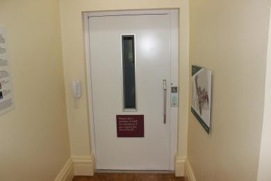 Corridor of lift with closed lift door in centre