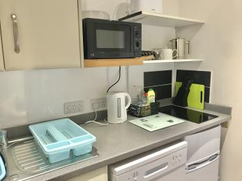 Kitchenette area with mini fridge/freezer and dishwasher