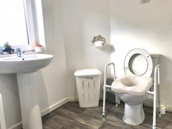 Raised toilet seat availalbe to borrow at the Courtyard Studio