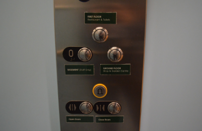 Image of lift buttons inside, with printed labels for each button.