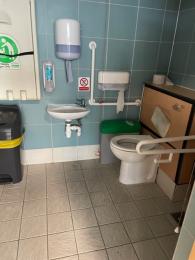 One of several large toilets with wide entrance and space for wheelchairs and handrails both sides