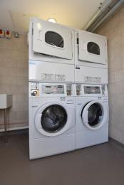 Laundry Room washer and driers, driers are at the top of the units, hand wash deep sink and ironing board available.