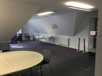 Image shows entrance of the Learning Loft. A table can be seen on the lower right hand space and a large open space can be seen 