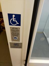 Lift call buttons saying 'press button to unlock door or wait until lift arrives'