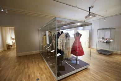 Room with dresses in cases in the centre