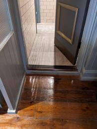 Photograph of step into men's ground floor bathroom