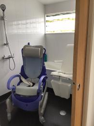 Opal bedroom 6 showing Arjo Carendo multipurpose hygiene chair. 